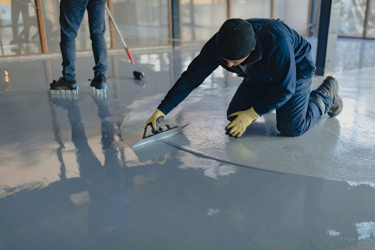 A man polishing floor with epoxy